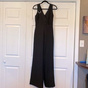 Wide leg sleeveless V-neck and V-back black jumpsuit, brand new never worn. Sz S
